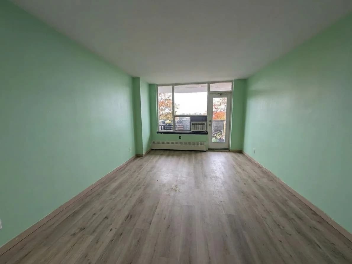 Living room after: empty, with the floor swept