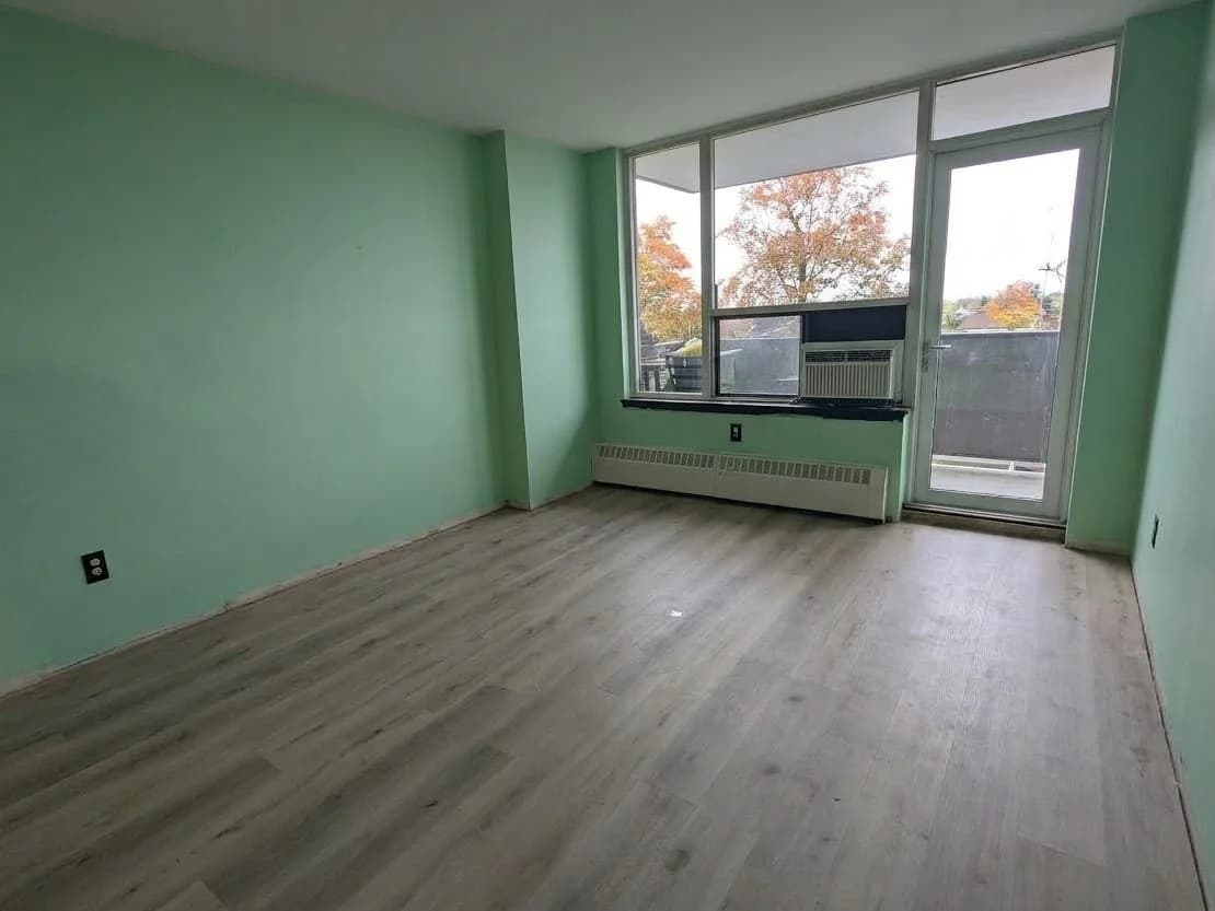 Living room after: bare walls and floor in front of the window