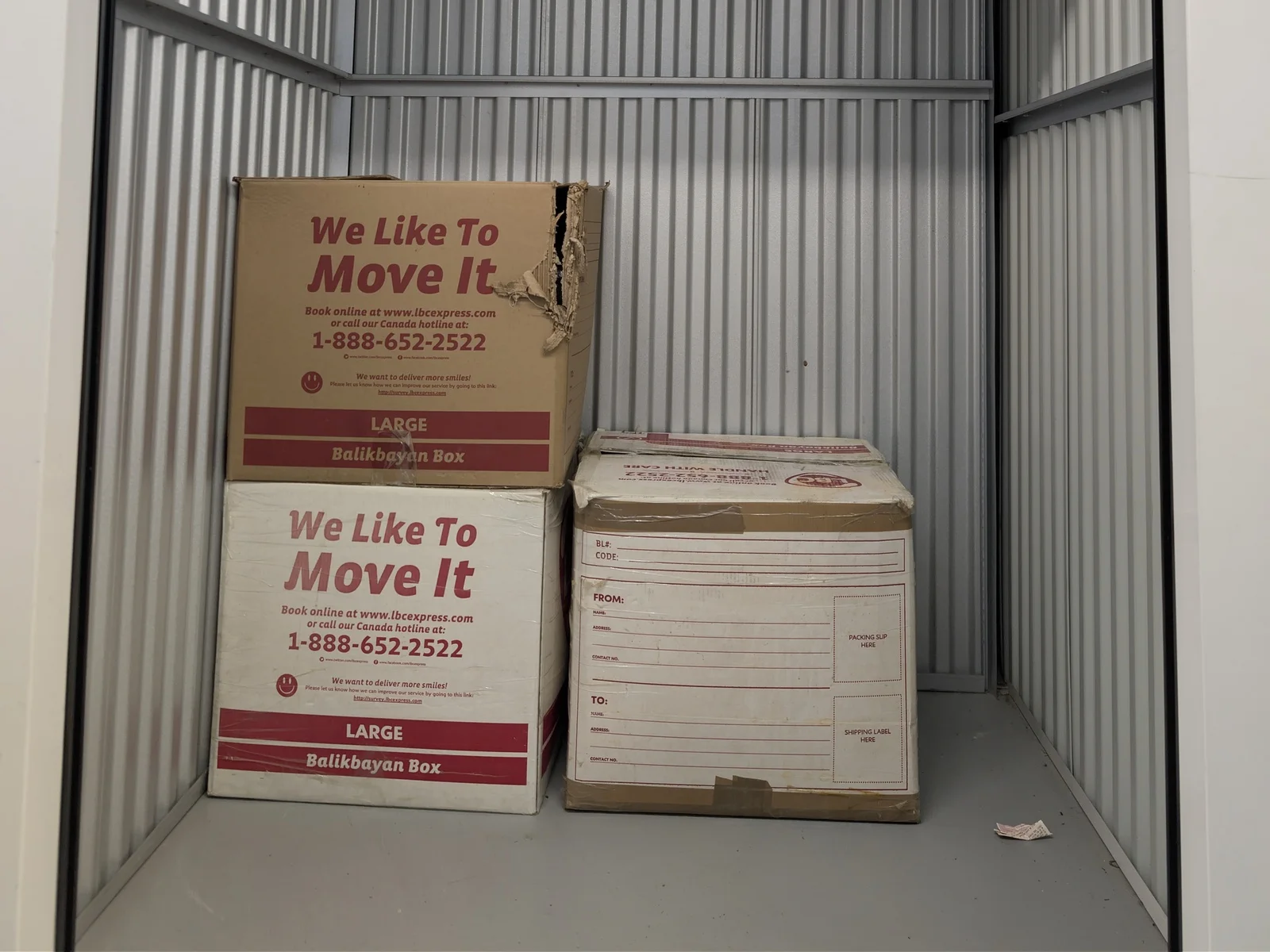 Storage unit before: three boxes in an empty unit